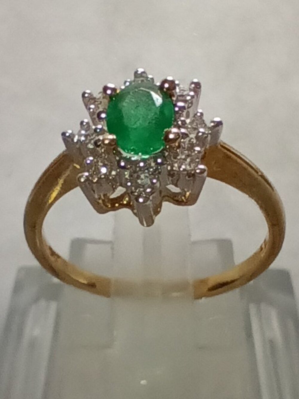10Kt Yellow Gold Half-Carat Oval Emerald & Round Diamond Halo-Style Ring